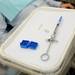 Jean-Claude Soloman's new implants, screws to hold them in place and a numbing syringe are laid out on a tray.  Melanie Maxwell I AnnArbor.com